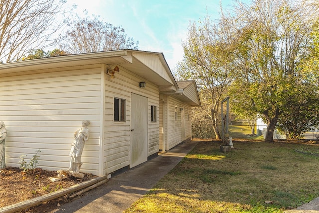 view of side of home with a yard and fence