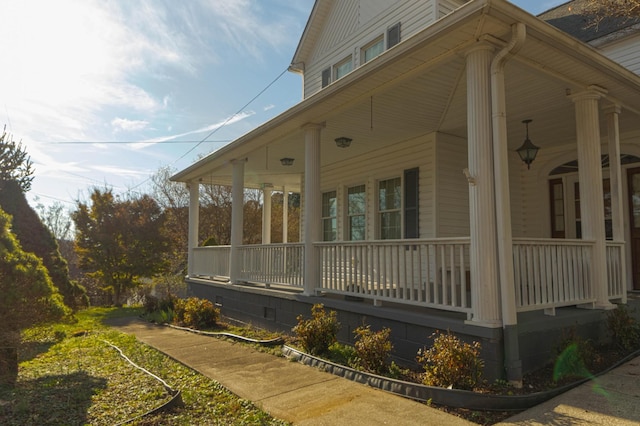 view of side of property featuring covered porch