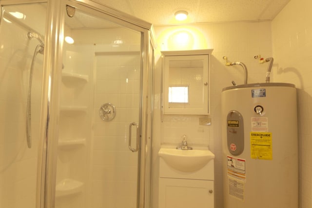 full bath with vanity, water heater, a shower stall, a textured ceiling, and tile walls