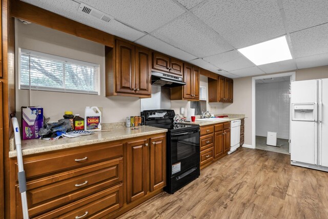 253 Main St, Ducktown, TN 37326 - kitchen featuring white appliances, under cabinet range hood, light countertops, a sink, and a paneled ceiling