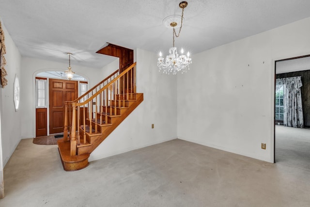 253 Main St, Ducktown, TN 37326 - carpeted entrance foyer with a chandelier, stairway, and baseboards
