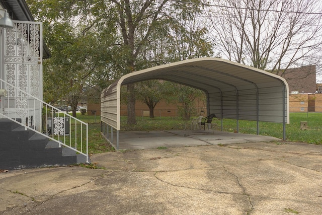 view of parking / parking lot with a carport and concrete driveway