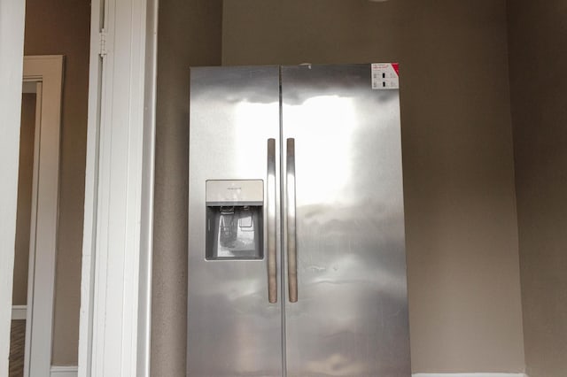 interior details featuring stainless steel fridge with ice dispenser