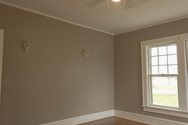 unfurnished room featuring wood finished floors, baseboards, ceiling fan, and crown molding