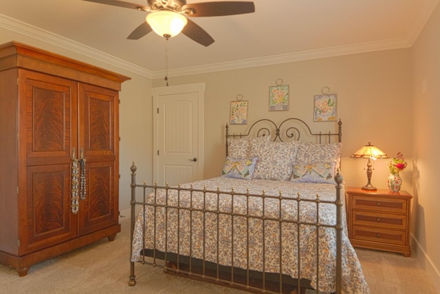 bedroom with baseboards, light carpet, ornamental molding, and a ceiling fan