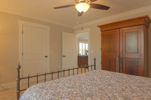 bedroom with carpet flooring, baseboards, a ceiling fan, and crown molding