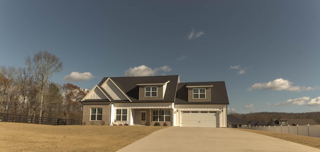 view of front of property featuring brick siding, concrete driveway, fence, and a garage