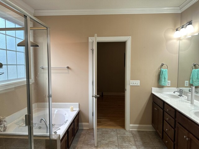 full bathroom with ornamental molding, a stall shower, a garden tub, and a sink