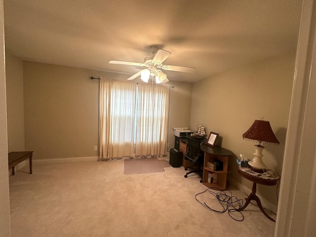 home office featuring carpet flooring, baseboards, and a ceiling fan