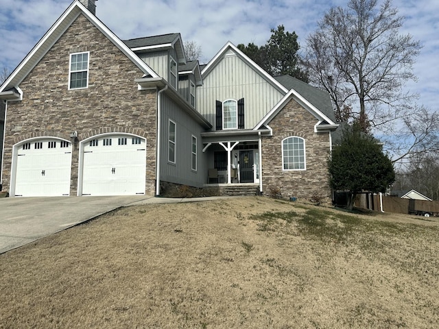 view of front facade featuring a garage, stone siding, board and batten siding, and driveway