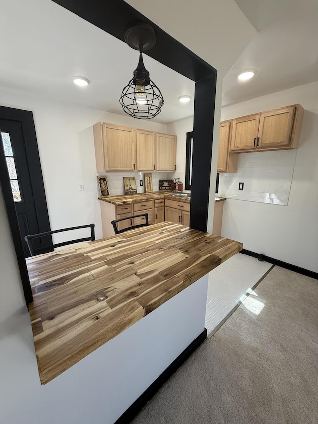 kitchen featuring recessed lighting, wood counters, carpet, and light brown cabinetry