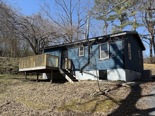 view of side of property featuring stairway, central AC unit, and a wooden deck