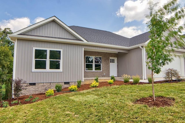 view of front facade featuring a garage, a front yard, a shingled roof, crawl space, and brick siding