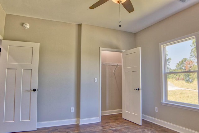 unfurnished bedroom with visible vents, a ceiling fan, dark wood finished floors, a closet, and baseboards