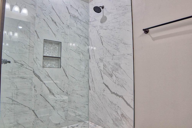 full bath featuring a marble finish shower