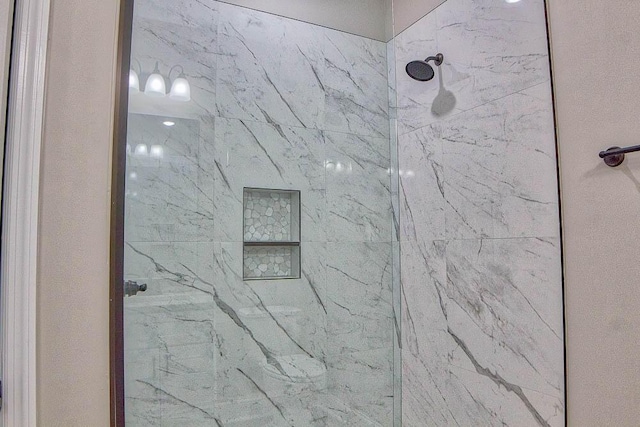 room details featuring a marble finish shower