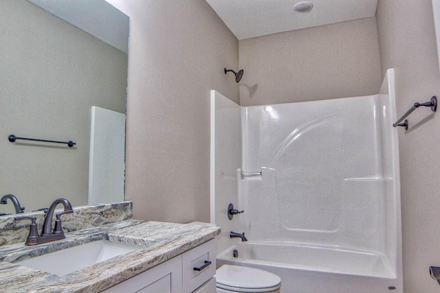 bathroom with vanity,  shower combination, and toilet