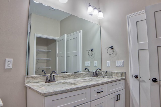 full bathroom featuring double vanity and a sink