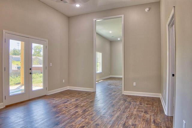 spare room with french doors, baseboards, and dark wood-style floors