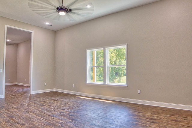 spare room featuring dark wood-style floors, visible vents, recessed lighting, and baseboards