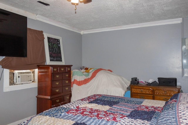 bedroom with visible vents, ornamental molding, a textured ceiling, cooling unit, and ceiling fan