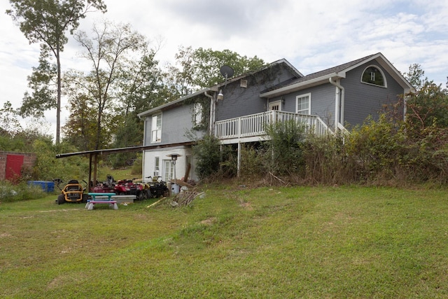 back of property featuring a yard and a deck