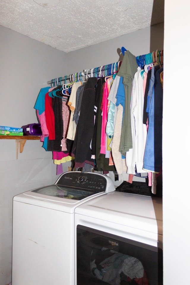 washroom featuring washer and dryer and a textured ceiling