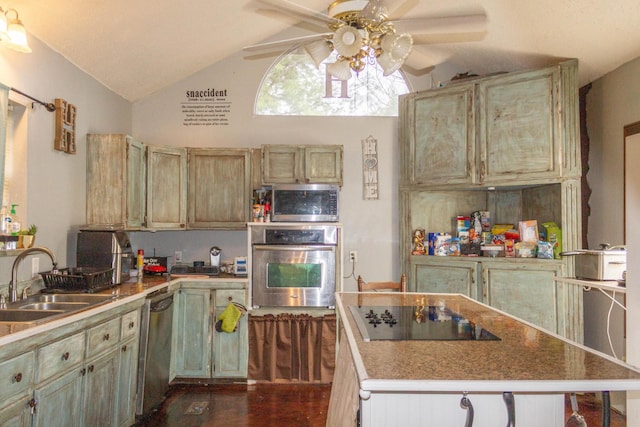 kitchen featuring a center island, stainless steel appliances, lofted ceiling, and a sink