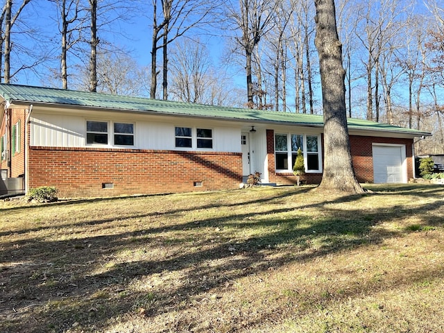 single story home featuring crawl space, a garage, metal roof, and brick siding