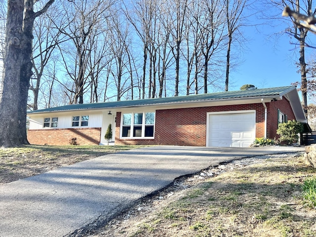 single story home featuring brick siding and a garage