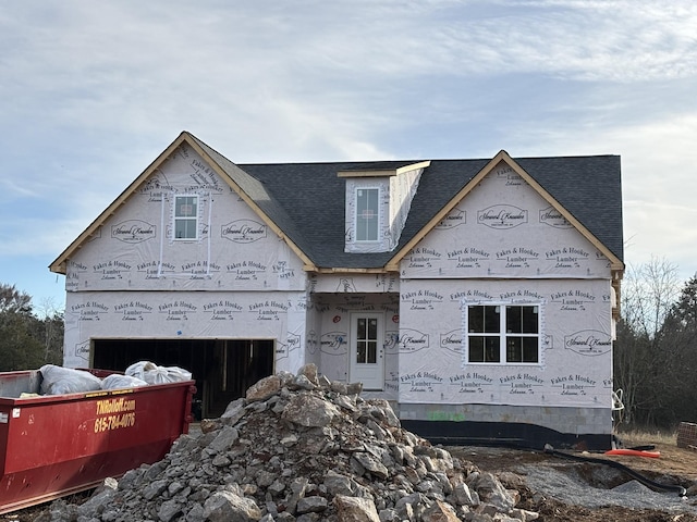 unfinished property featuring an attached garage