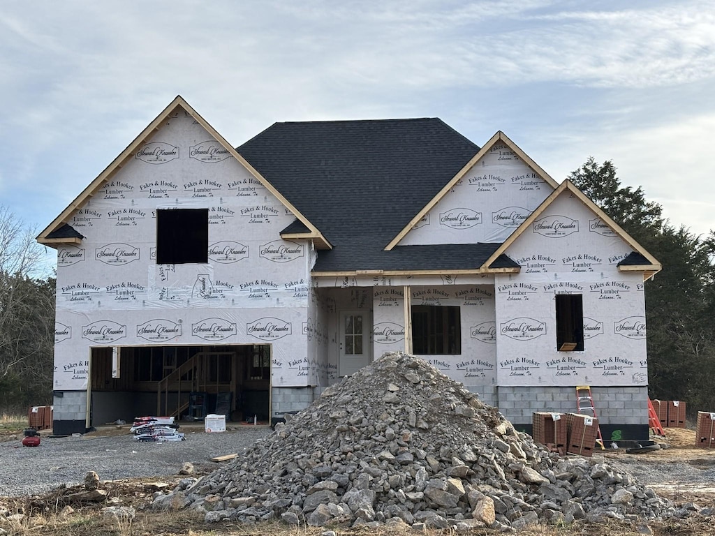 property under construction featuring roof with shingles