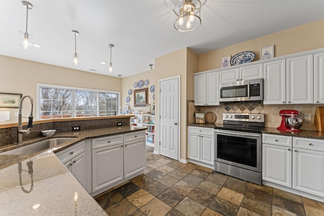 kitchen with white cabinetry, appliances with stainless steel finishes, and a sink