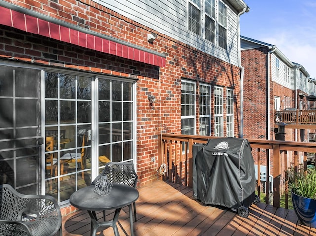 wooden terrace with a grill