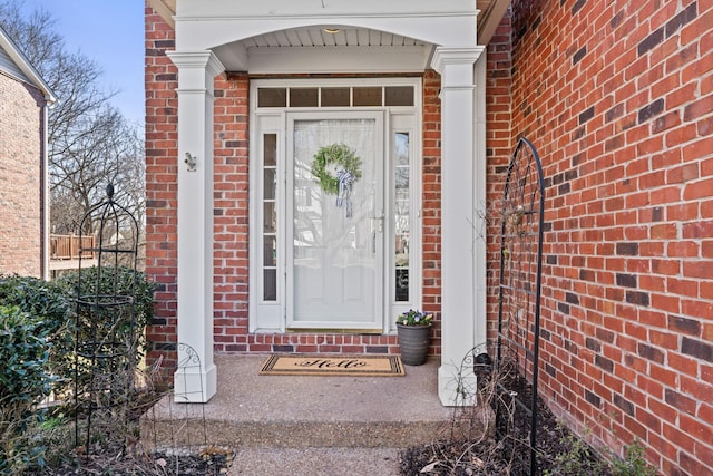 doorway to property with brick siding