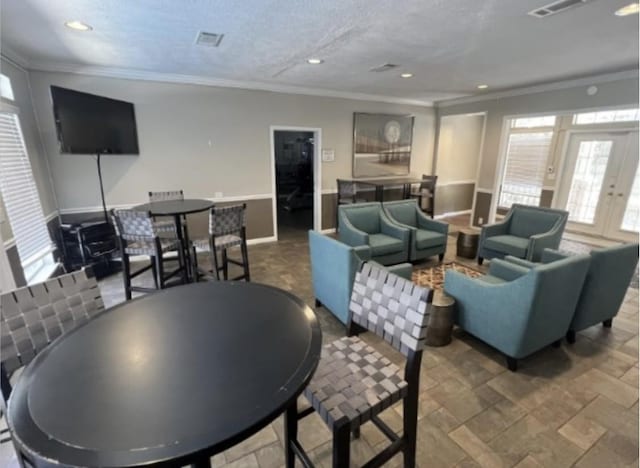 living area featuring crown molding, recessed lighting, french doors, and a textured ceiling