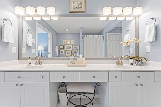 bathroom with double vanity, tile patterned floors, and a sink