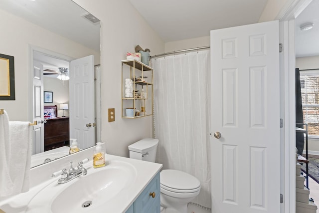 ensuite bathroom featuring vanity, visible vents, ceiling fan, ensuite bathroom, and toilet