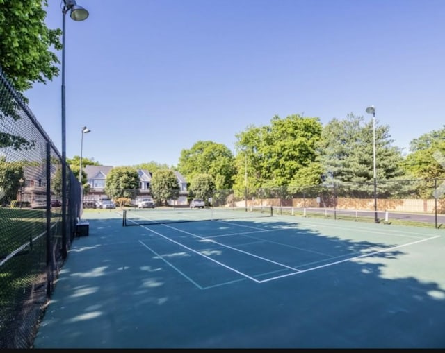 view of sport court with fence