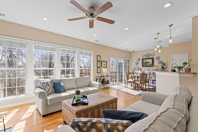 living room featuring visible vents, recessed lighting, and light wood-type flooring