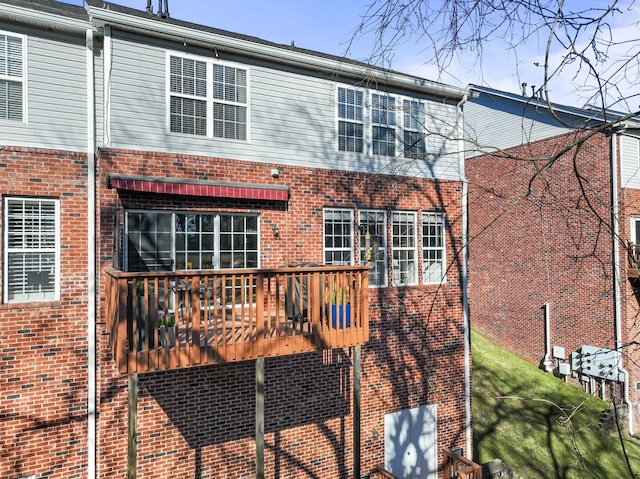 rear view of house featuring brick siding