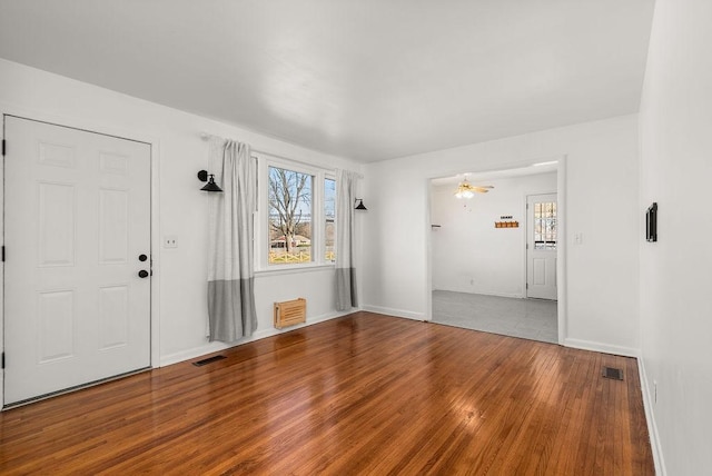 foyer with visible vents, a healthy amount of sunlight, and wood finished floors