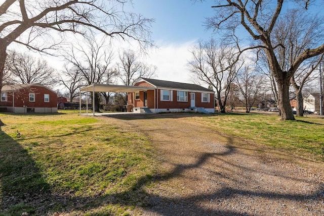 view of front facade featuring a front lawn, brick siding, and dirt driveway