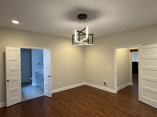 unfurnished dining area with recessed lighting, baseboards, and dark wood-style floors