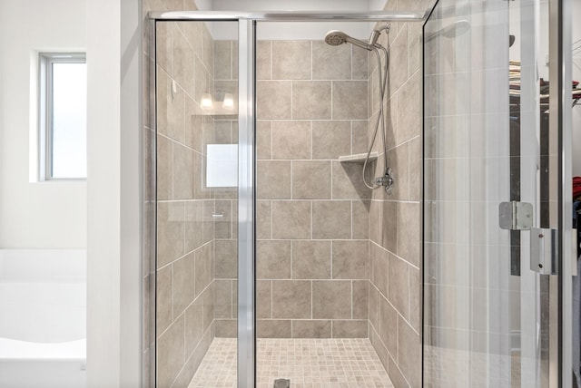 full bath featuring a bath and a shower stall