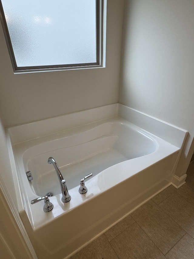 full bath with tile patterned floors and a bath