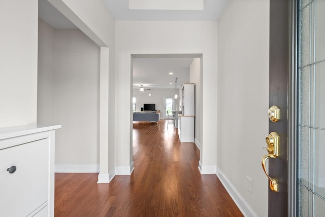 foyer entrance featuring wood finished floors and baseboards