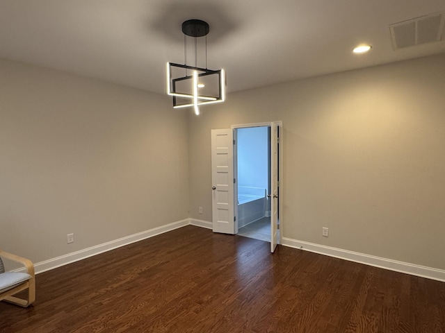 empty room featuring recessed lighting, visible vents, baseboards, and dark wood-style flooring