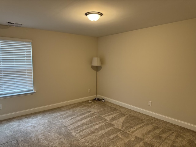 spare room with visible vents, baseboards, and carpet floors