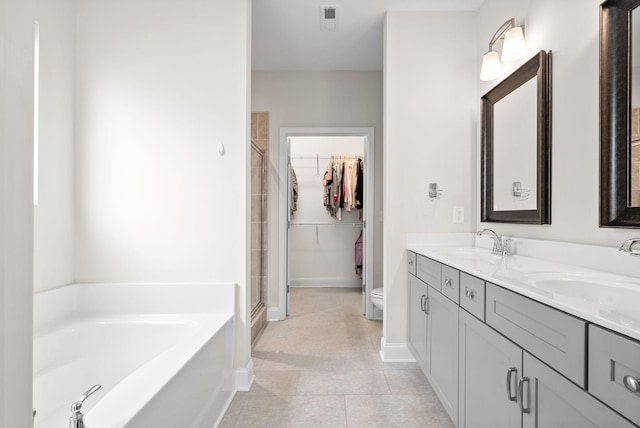 full bathroom featuring visible vents, a shower stall, a garden tub, and a sink